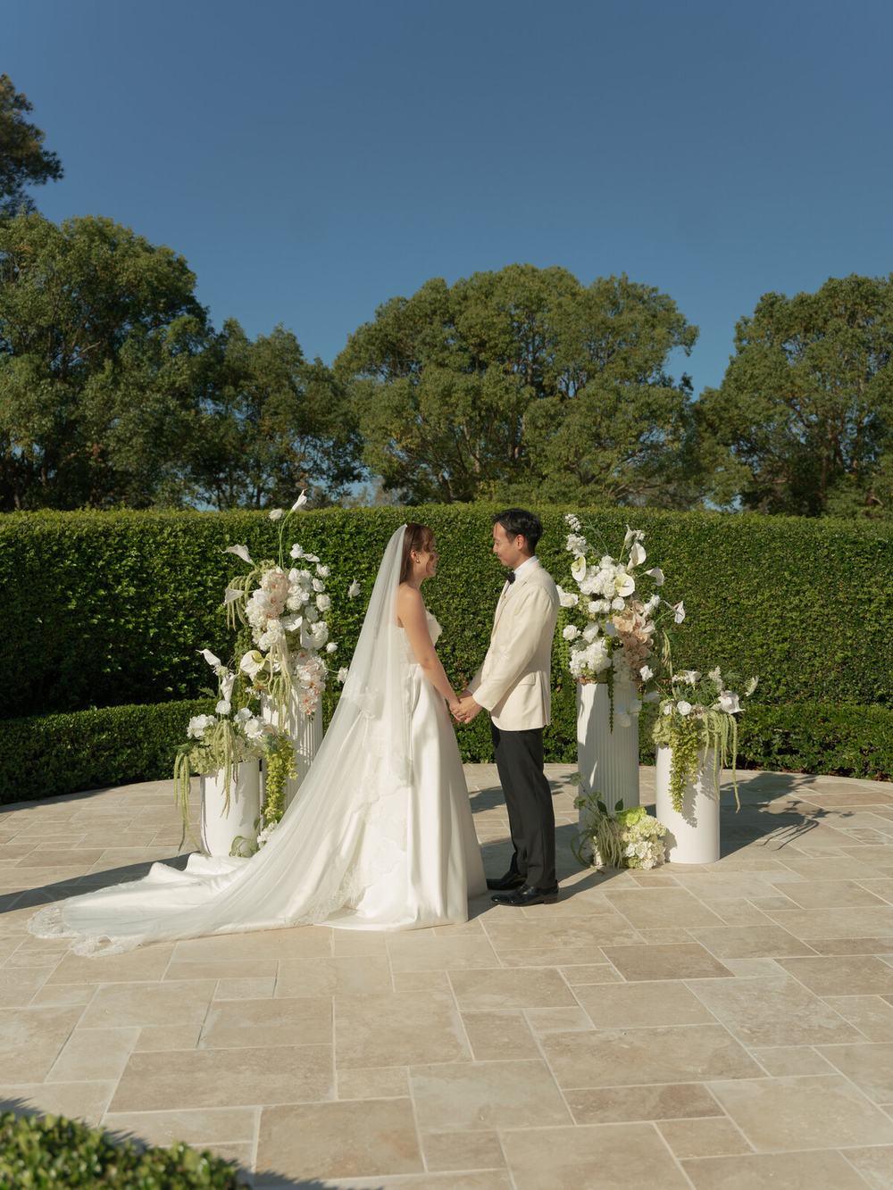 Wedding ceremony in a garden, seen from the back of the seats